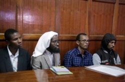 FILE -From left to right: defendants Rashid Charles Mberesero, Sahal Diriye Hussein, Hassan Aden Hassan and Mohamed Abdi Abikar, sit in the dock to hear their verdict at a court in Nairobi, Kenya, June 19, 2019.