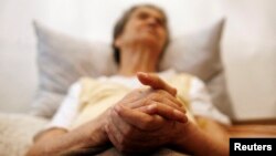 FILE - Alzheimer's disease patient Isidora Tomaz, 82, sits in an armchair in her house in Lisbon, Portugal. It’s predicted that by 2050, 135 million Americans are going to suffer from mild cognitive impairment, a precursor of Alzheimer's.