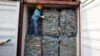 A worker stands inside a container full of plastic waste at Tanjung Priok port in Jakarta, Indonesia. Indonesia is sending hundreds of containers of waste back to Western nations after finding they were contaminated with used plastic and hazardous materials.