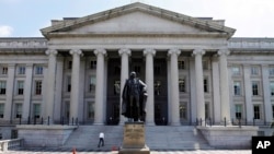 FILE - A statue of former Treasury Secretary Albert Gallatin stands outside the Treasury Building in Washington.