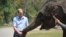 Britain's Prince William feeds a baby elephant in the wild elephant valley in Xishuangbanna, or Sibsongbanna Dai autonomous prefecture, southwest China's Yunnan province, March 4, 2015. 
