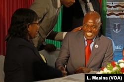 Opposition Malawi Congress Party General Secretary, Eisenhower Mkaka, cracks jokes with MEC chairperson Jane Ansah as he signed a code of conduct,Tuesday in Lilongwe.