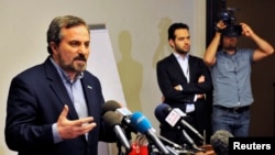 Louay al-Safi, Syrian National Coalition spokesman, left, addressing news conference, Istanbul, May 26, 2013.