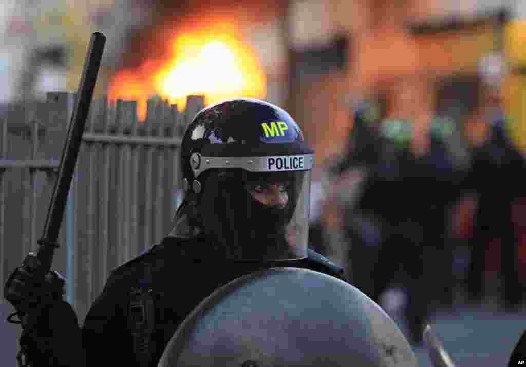 British police officers are deployed during riots in Hackney, east London, Monday Aug. 8, 2011. Youths set fire to shops and vehicles in a host of areas of London _ which will host next summer's Olympic Games _ and clashed with police in the nation's cent