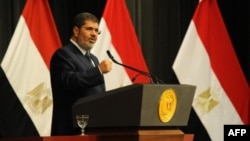 FILE - Egyptian President Mohamed Morsi addresses a conference June 26, 2013 in Cairo (Egyptian Presidency photo)