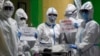 Health workers wearing protective suits holds signs with a 16-day-old baby who recovered from COVID-19 as he is discharged from the National Children&#39;s Hospital in Quezon city, Metro Manila, Philippines .