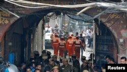 Members of India's National Disaster Response Force (NDRF) head towards the site of a fire that swept through a factory where laborers were sleeping, in New Delhi, India December 8, 2019. REUTERS/Adnan Abidi - RC2TQD9DPDN9