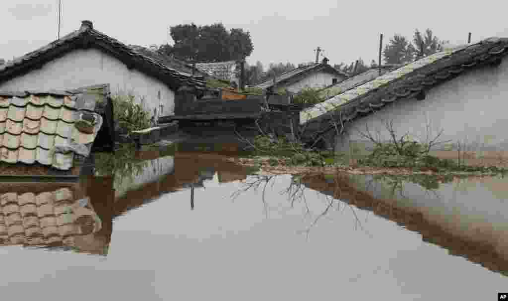 Houses are submerged in a flood water in Anju City, South Phyongan Province, North Korea, July 30, 2012. 