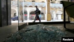 A passerby inspects the site of a blast that hit central Cairo Tuesday. A man was killed in a bomb blast in Alexandria, Egypt, hours after two devices were discovered at Cairo airport, Feb. 3, 2015.