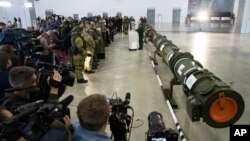 Foreign military attaches and journalists attend a briefing by the Russian Defense Ministry as the 9M729 land-based cruise missile, right, in Kubinka, Russia, Jan. 23, 2019.