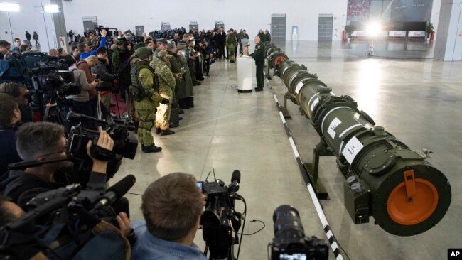 Foreign military attaches and journalists attend a briefing by the Russian Defense Ministry as the 9M729 land-based cruise missile, right, in Kubinka, Russia, Jan. 23, 2019.