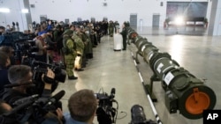 FILE - Foreign military attaches and journalists attend a briefing by the Russian Defense Ministry about the 9M729 land-based cruise missile, right, in Kubinka, Russia, Jan. 23, 2019. 