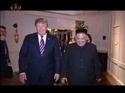 In this image made from video released on Wednesday, March 6, 2019, by North Korean broadcaster KRT, North Korean leader Kim Jong Un, right, smiles while walking with U.S.