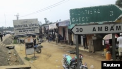 FILE - Signs are seen on the border with Equatorial Guinea and Gabon in Kye Ossi, Cameroon, May 23, 2015.