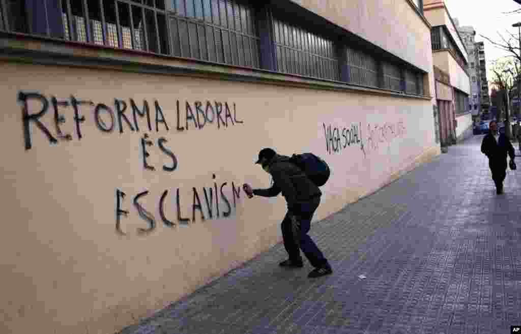 A demonstrator spraying graffiti in Barcelona, March 29, 2012. (AP)