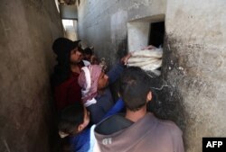 Syrians buy bread at a shop in the town of Binnish in the country's northwestern Idlib province on June 9, 2020.