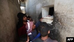 FILE - Syrians buy bread at a shop in the town of Binnish in the country's northwestern Idlib province on June 9, 2020.