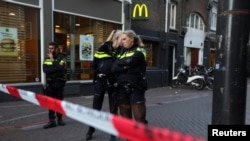 Police officers stand guard to secure the area where Dutch celebrity crime reporter Peter R. de Vries, known for his reporting on some of the most renowned criminals in the Netherlands, was shot and seriously injured, in Amsterdam, July 6, 2021.