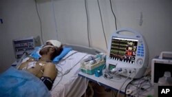 Injured Libyan lays in an intensive care until at Hikma hospital in the besieged city of Misrata, Libya, May 3, 2011