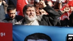 Hundreds of Syrians living in Turkey and human right activists shout anti-Assad slogans as they stage a protest outside the Syrian consulate to condemn the latest killings by Syrian regime in Syria, in Istanbul, Turkey, Sunday, Feb. 5, 2012.