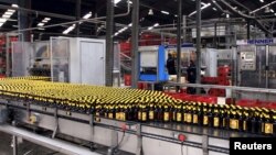 Beer bottles roll through a processing line at the St. George brewery in Ethiopia's capital, Addis Ababa, March 28, 2015.