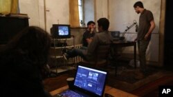 From left to right, Getsy Harutyunyan, Victor Zatikyan, Arman Arutyunian and Yervand Vardanyan talk at a house rented by a group of youths to practice their art activities in Yerevan, May 4, 2018. Many young hopefuls believe that major political changes in this poverty-ridden former Soviet republic could bring back many Armenians who fled the country to seek their fortunes abroad.