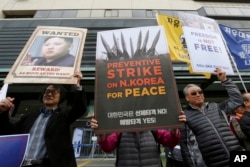 FILE - South Koreans protest against North Korea and Kim Jong Un during a rally near the U.S. Embassy in Seoul, South Korea, Nov. 6, 2017.