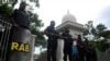 FILE - Members of the controversial Rapid Action Battalion (RAB) stand guard in front of the high court in Dhaka, Bangladesh, Aug. 1, 2013.