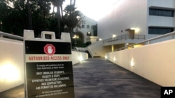 This Sept. 17, 2020, photo shows a sign for "Authorized Access Only" for visitors to the San Diego State University campus in San Diego, Calif. 