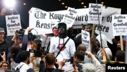 Demonstrators protest against what they see as an inadequate response to last month's Grenfell Tower fire, outside a Kensington and Chelsea Council meeting, at Kensington Town Hall in London, Britain, July 19, 2017.