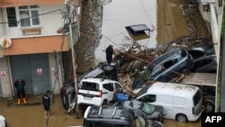TOPSHOT - Car owners search for their vehicles swept away by the flood after a heavy rain at Ayazaga district in Istanbul, on October 15,2026.