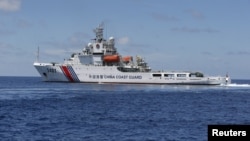  A Chinese Coast Guard vessel is pictured on the disputed Second Thomas Shoal, part of the Spratly Islands, in the South China Sea March 29, 2014. Picture taken March 29, 2014. REUTERS/Erik De Castro - RTS8X3M