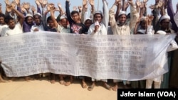 Some Rohingya refugees in Cox's Bazar, Bangladesh, are protesting against the community's repatriation to Myanmar, carrying a festoon on which their demands for repatriation are written. 