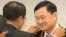 Former Thai Prime Minister Thaksin Shinawatra, right, receives a medal from Cambodia's Prime Minister Hun Sen, center, during the Medal Decoration ceremony at Cambodia Peace Palace in Phnom Penh, Monday, Sept. 19, 2011.