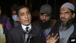File - Lawyer Nadeem Ahmed Azar, L, and Sheikh Muhammad Aslam, brother of British-born Pakistani Ahmed Omar Saeed Sheikh, who is charged in the murder of American journalist Daniel Pearl, talks to media outside a prison in Karachi, Pakistan, Dec. 24, 2020