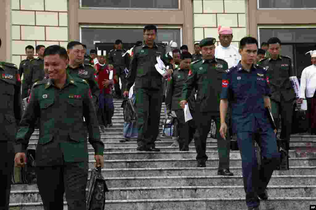 Military representatives and lawmakers arrive to attend a regular session of the lower house of Parliament, Tuesday, Aug. 18, 2015, in Naypyitaw, Myanmar. Myanmar's parliament reopened Tuesday for its final session before November's national elections, with the spotlight on the influential speaker — who was violently ousted just days ago as head of the military-backed ruling party. (AP Photo/Khin Maung Win)