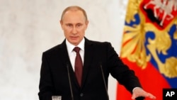 FILE - Russia's President Vladimir Putin addresses the Federation Council in Moscow's Kremlin, March 18, 2014.