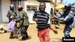Anti-riot and military policemen disperse supporters of Uganda's Forum for Democratic Change (FDC) leader Kizza Besigye during a protest in Kireka suburb of the capital Kampala, April 18, 2011. Ugandan opposition leader Besigye was charged in court on Mon