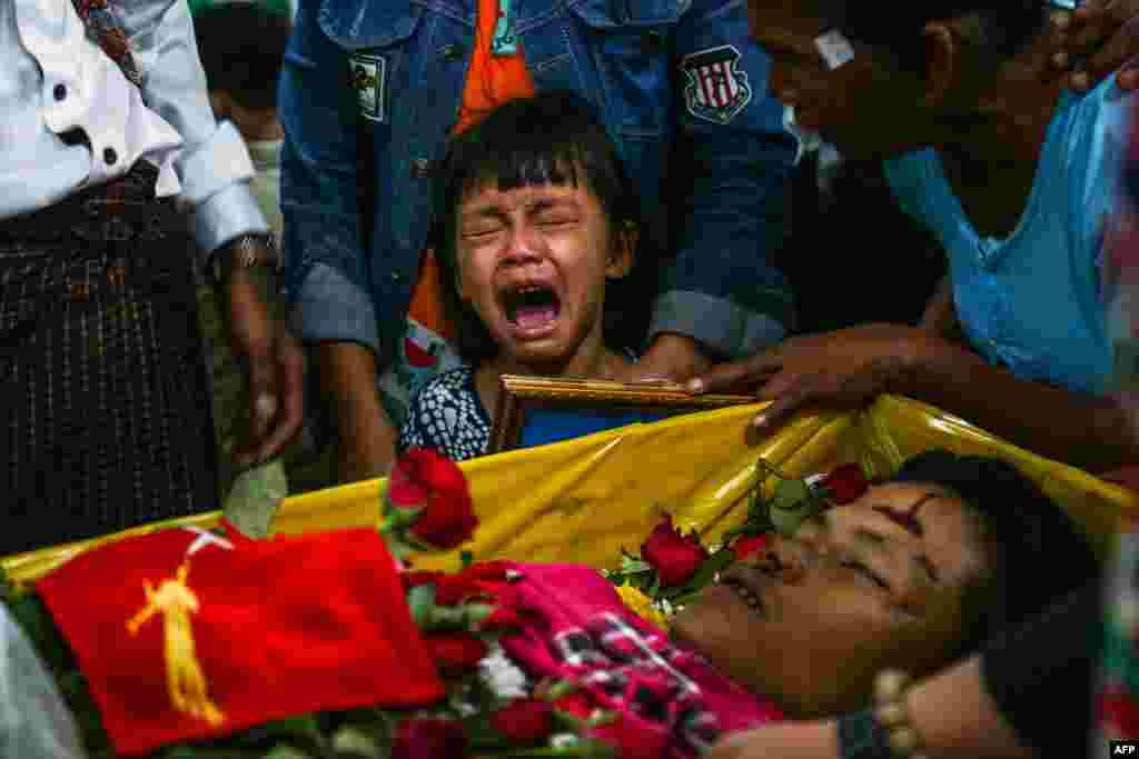 The daughter of Zwee Htet Soe, a protester who died during a demonstration against the military coup on March 3, cries during her father&#39;s funeral in Yangon.
