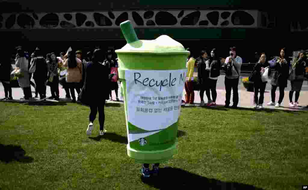 A volunteer, wearing a disposable cup costume, participates in an environmental campaign as part of Earth Day celebrations in front of Seoul City Hall in Seoul, South Korea, April 22, 2013.