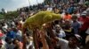 FILE: Supporters of Zimbabwe's President in waiting Emmerson Mnangagwa, known as "The Crocodile", raise a stuffed crocodile in the air as they await his arrival at the Zanu-PF party headquarters in Harare, Zimbabwe, Nov. 22, 2017.