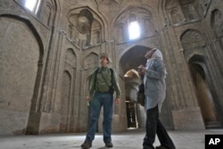 FILE - Canadian tourist David Froud and his Iranian wife, Mahnaz, sightsee at the Jomeh mosque, which is now a historical monument, in the city of Isfahan, about 390 kilometers south of Tehran, Iran, April 8, 2011.