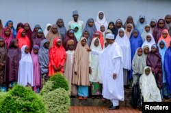 Nigeria's President Muhammadu Buhari meets with some of the newly released Dapchi schoolgirls in Abuja, Nigeria, March 23, 2018.