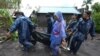 Rescuers carry the body of a man who drowned in floods as Typhoon Goni hit Guinobatan, Albay province, central Philippines, Nov. 1, 2020.