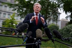 FILE - National Security Adviser John Bolton talks to reporters outside the White House, May 1, 2019.