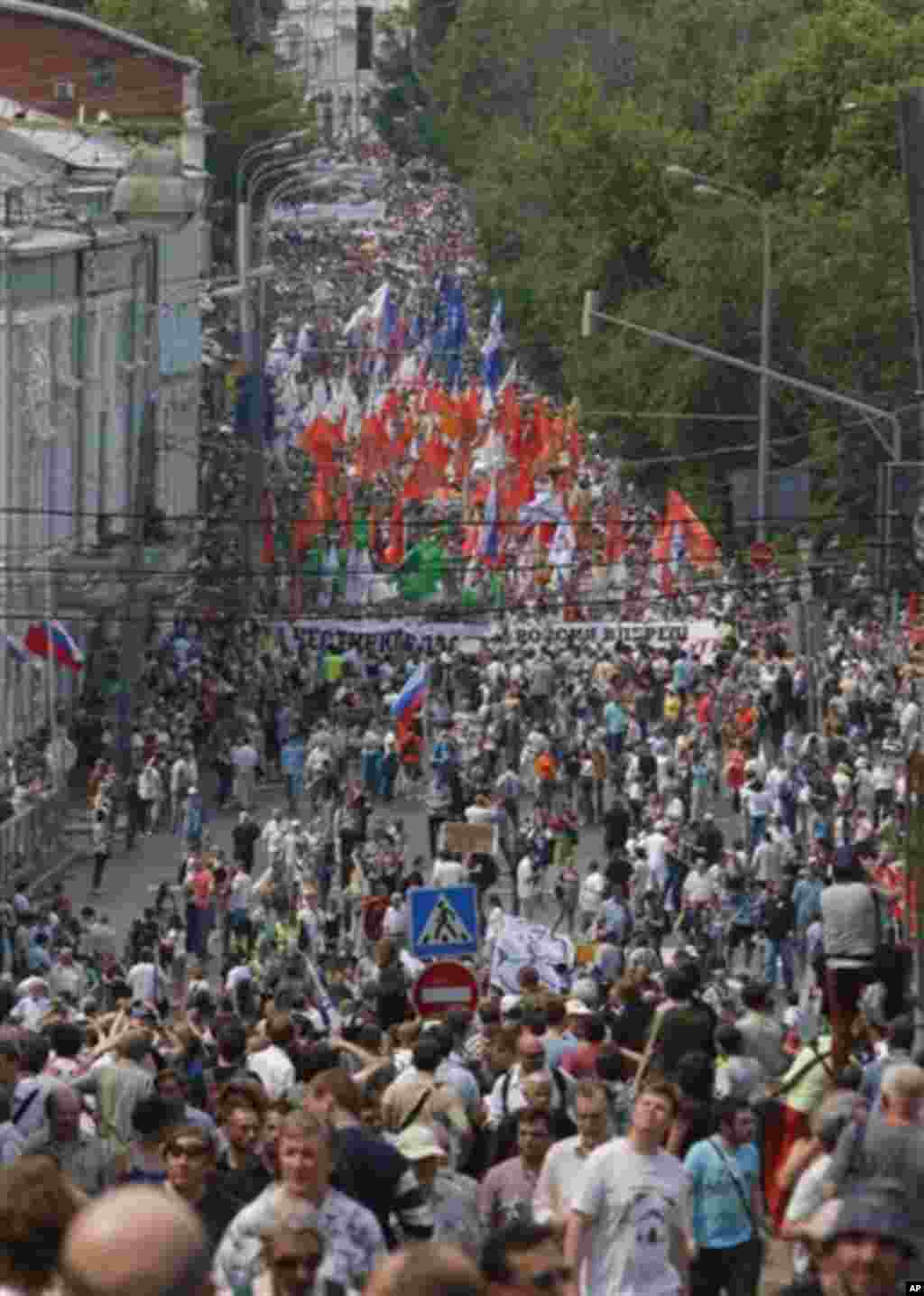 Opposition members march in central Moscow on Tuesday, June 12, 2012. Tens of thousands of Russians flooded Moscow's tree-lined boulevards Tuesday in the first massive protest against President Vladimir Putin's rule since his inauguration, as investigato