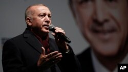 Turkey's President Recep Tayyip Erdogan addresses the supporters of his ruling Justice and Development Party, AKP, at a rally in Istanbul, March 19, 2019.