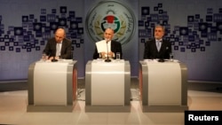 Afghan presidential candidate Ashraf Ghani Ahmadzai (C) speaks as candidates Abdullah Abdullah (R) and Qayum Karzai (L) listen during the presidential election debate at the studio of a local TV channel in Kabul, Feb. 8, 2014.