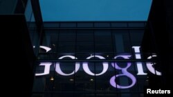 FILE - The sign marking the Google offices is lit up in Cambridge, Massachusetts, U.S., June 27, 2017. 