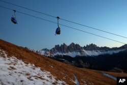 A chairlift is pictured in front of the Geisler group massif at the Dolomites mountains near Bressanone, autonomous region of South Tyrol, northern Italy's German-Italian speaking region, Nov. 26, 2020.